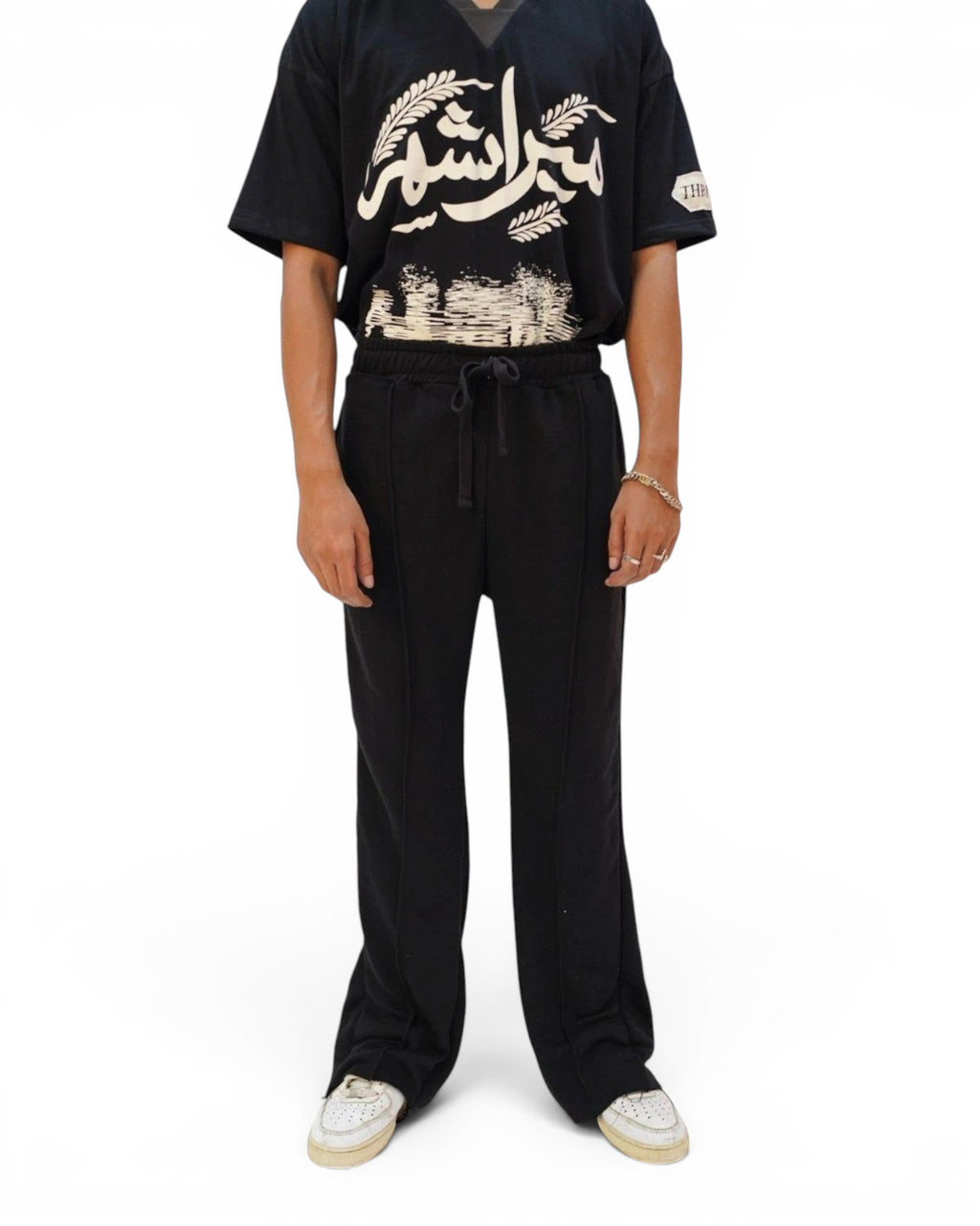 Thrive black pleated flared trousers in terry fabric with an elasticated drawstring waist and raw hem