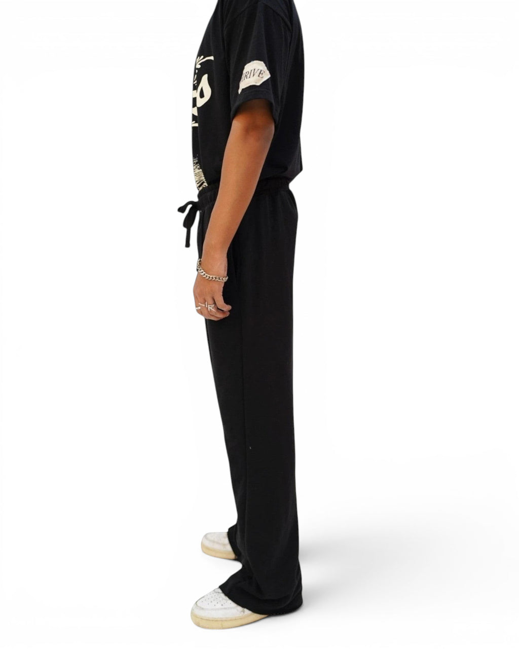 Thrive black pleated flared trousers in 250 gsm terry fabric with an elasticated drawstring waist and raw hem.